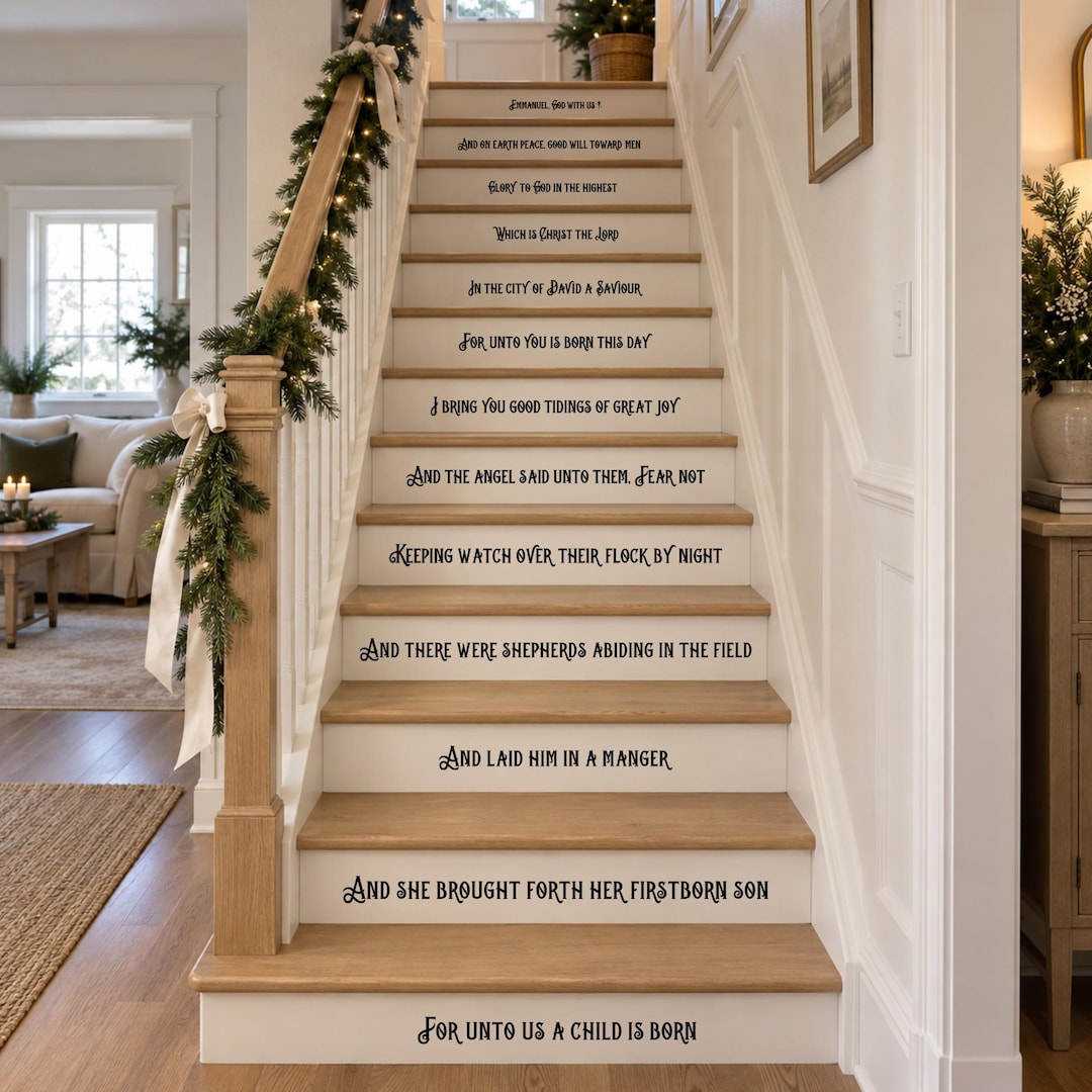Christmas Story Bible verse stair riser decals in black vinyl on wood stairs with a Christmas tree and garland, from For unto us a child is born to Emmanuel, God with us